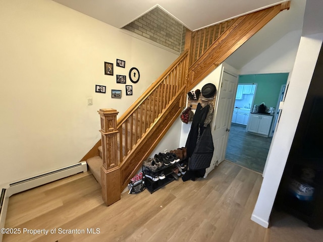 stairway featuring hardwood / wood-style flooring and a baseboard radiator