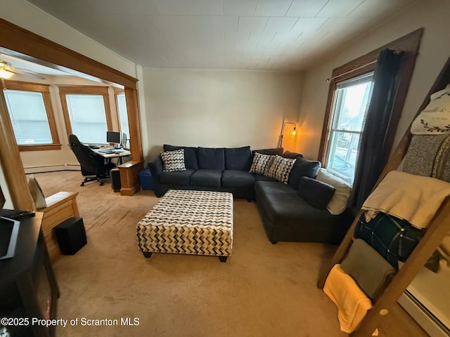 carpeted living room featuring a baseboard heating unit