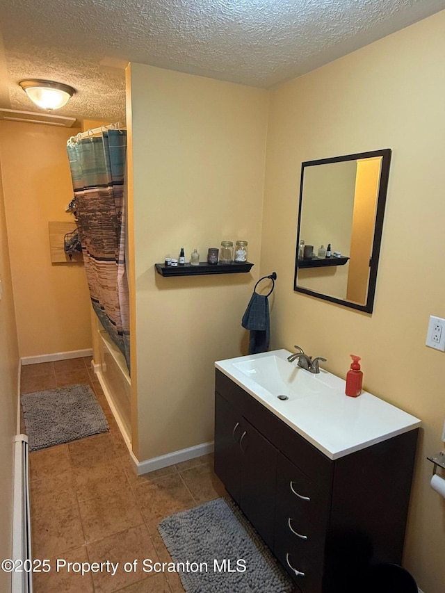 bathroom with vanity, tile patterned floors, shower / bathtub combination with curtain, and a textured ceiling