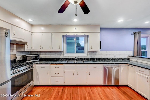 211 Hill St, Dupont, PA 18641 - kitchen with stainless steel appliances, under cabinet range hood, white cabinetry, light wood-style flooring, and recessed lighting