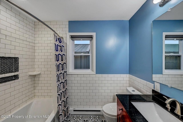 211 Hill St, Dupont, PA 18641 - bathroom featuring baseboard heating, tile walls, shower / bath combo, vanity, and plenty of natural light
