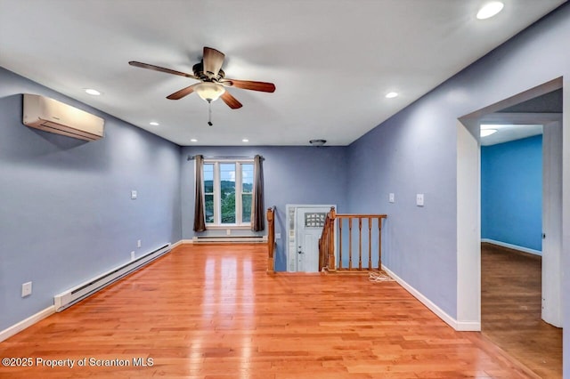 211 Hill St, Dupont, PA 18641 - unfurnished room featuring a baseboard radiator, an AC wall unit, light wood-style flooring, ceiling fan, and recessed lighting
