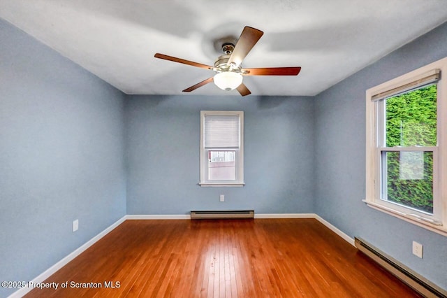 211 Hill St, Dupont, PA 18641 - unfurnished room featuring a baseboard radiator, healthy amount of natural light, and hardwood / wood-style flooring