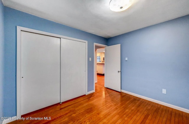 211 Hill St, Dupont, PA 18641 - unfurnished bedroom featuring wood-type flooring and a closet