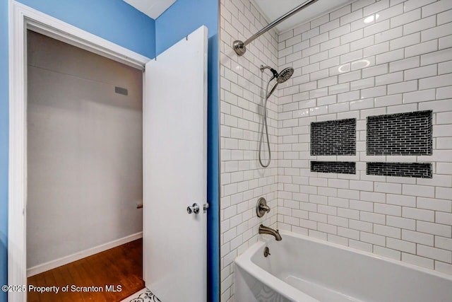 211 Hill St, Dupont, PA 18641 - bathroom featuring shower / washtub combination and wood finished floors