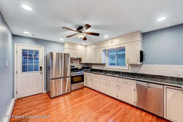 211 Hill St, Dupont, PA 18641 - kitchen with stainless steel appliances, ceiling fan, tasteful backsplash, light wood-type flooring, and white cabinets