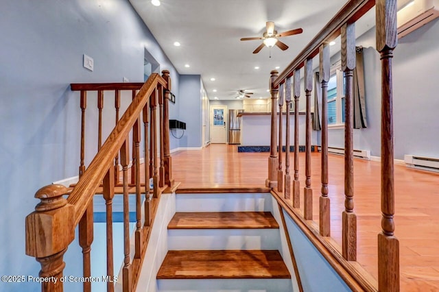 211 Hill St, Dupont, PA 18641 - staircase featuring a ceiling fan, recessed lighting, wood finished floors, and a baseboard radiator