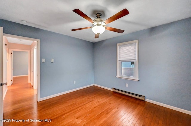 211 Hill St, Dupont, PA 18641 - spare room featuring a baseboard heating unit, hardwood / wood-style flooring, and a ceiling fan