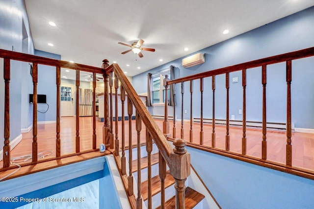 211 Hill St, Dupont, PA 18641 - staircase featuring a wall mounted air conditioner, a ceiling fan, a baseboard radiator, and recessed lighting