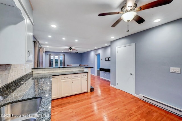 211 Hill St, Dupont, PA 18641 - kitchen with a baseboard heating unit, a ceiling fan, a peninsula, white cabinetry, and recessed lighting