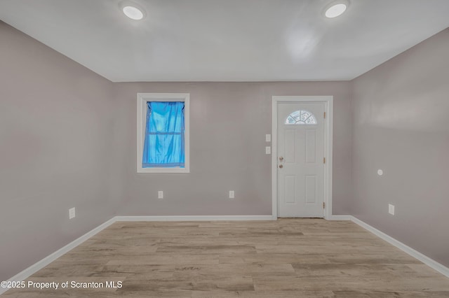 foyer entrance with light hardwood / wood-style floors