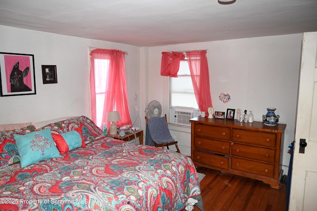 bedroom featuring cooling unit and wood finished floors