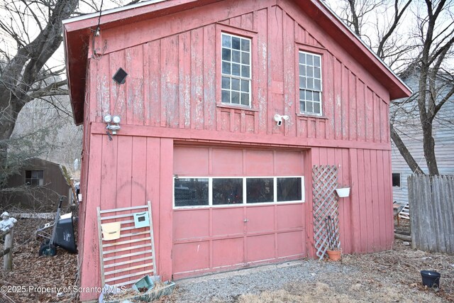 view of home's exterior featuring a detached garage and an outbuilding