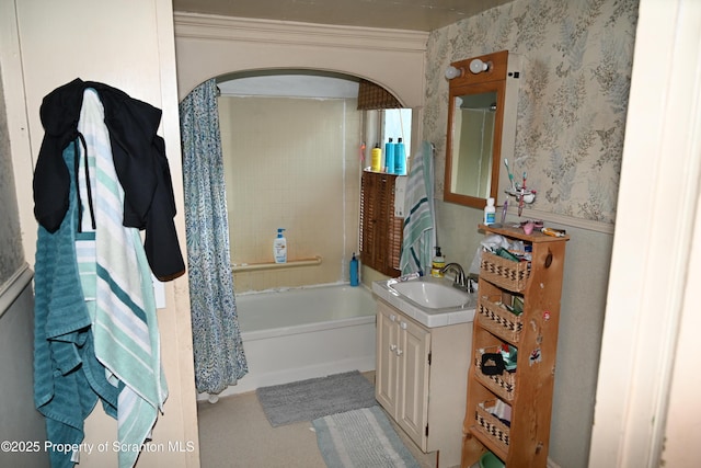 bathroom with crown molding, shower / tub combo, vanity, and wallpapered walls