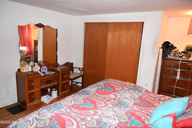 bedroom with a closet and wood finished floors