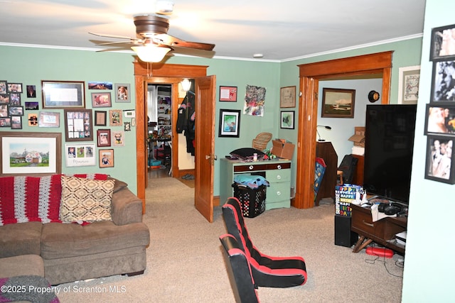 living area with carpet, crown molding, and ceiling fan