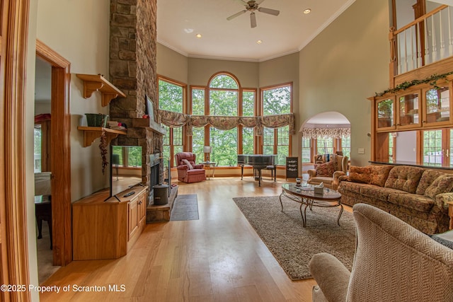 72 Adams Dr, Waymart, PA 18472 - living area with a high ceiling, light wood-style floors, ceiling fan, ornamental molding, and a fireplace
