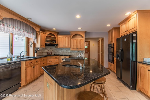 72 Adams Dr, Waymart, PA 18472 - kitchen with black appliances, light tile patterned flooring, a kitchen bar, decorative backsplash, and a kitchen island with sink