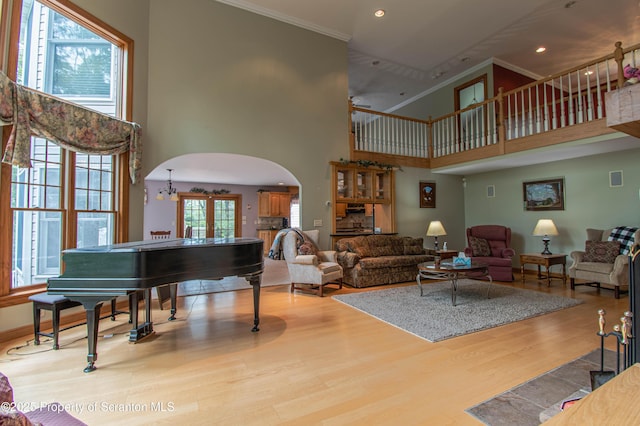 72 Adams Dr, Waymart, PA 18472 - living area with arched walkways, a high ceiling, wood finished floors, ornamental molding, and recessed lighting
