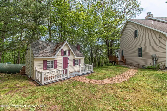 72 Adams Dr, Waymart, PA 18472 - view of grassy yard with an outdoor structure and a wooden deck