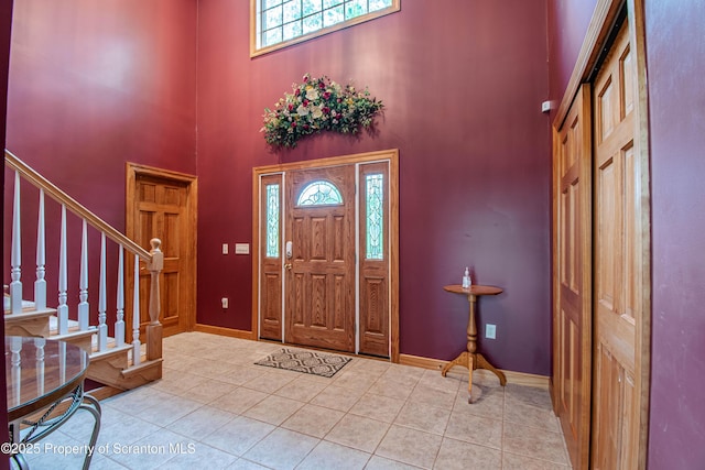 72 Adams Dr, Waymart, PA 18472 - entryway with a high ceiling, stairway, and light tile patterned floors