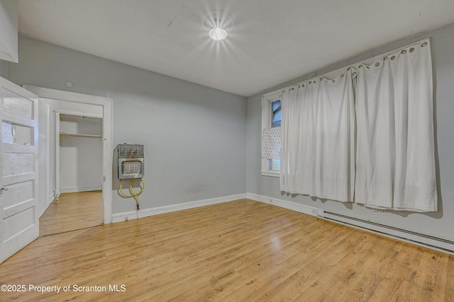 167 S Hyde Park Ave, Scranton, PA 18504 - unfurnished bedroom with heating unit, wood finished floors, and a baseboard radiator