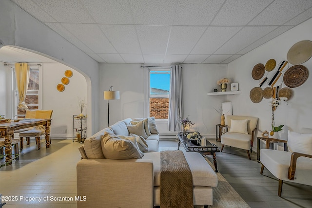 167 S Hyde Park Ave, Scranton, PA 18504 - living room featuring a paneled ceiling, arched walkways, hardwood / wood-style flooring, and baseboard heating