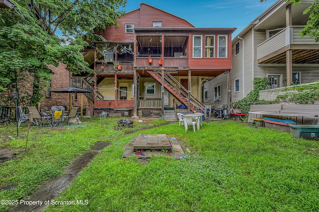 167 S Hyde Park Ave, Scranton, PA 18504 - back of house featuring a yard, a sunroom, an outdoor fire pit, stairway, and a wooden deck