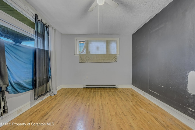 167 S Hyde Park Ave, Scranton, PA 18504 - spare room featuring baseboard heating, wood finished floors, a ceiling fan, and a textured ceiling