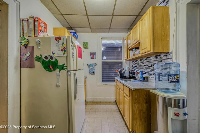 167 S Hyde Park Ave, Scranton, PA 18504 - kitchen with freestanding refrigerator, a drop ceiling, light countertops, backsplash, and light tile patterned floors