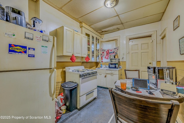 167 S Hyde Park Ave, Scranton, PA 18504 - kitchen featuring white appliances, a drop ceiling, and glass insert cabinets
