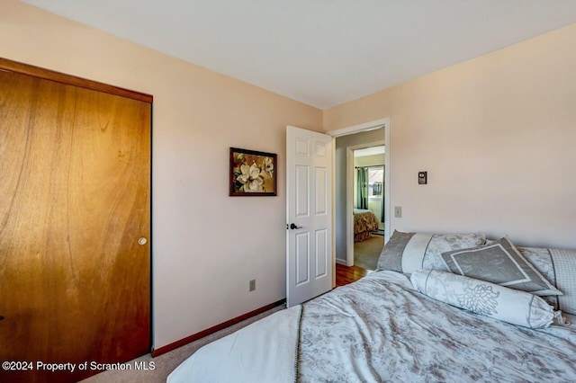 bedroom with a closet and dark colored carpet