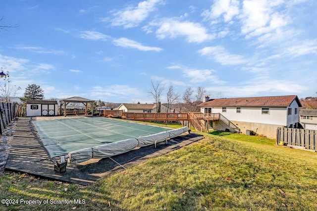 view of tennis court with a lawn and a shed