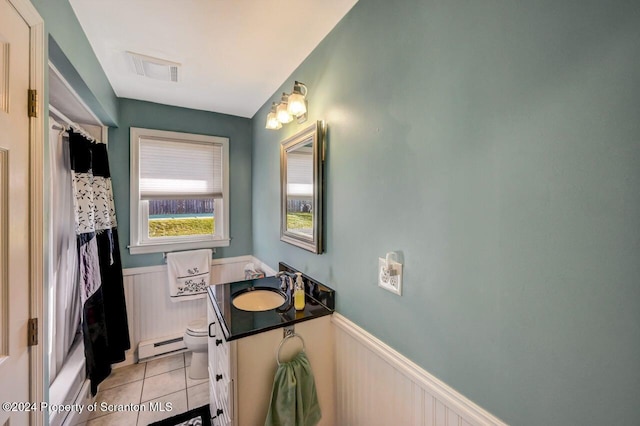 full bathroom featuring a baseboard heating unit, tile patterned floors, toilet, shower / tub combo with curtain, and vanity