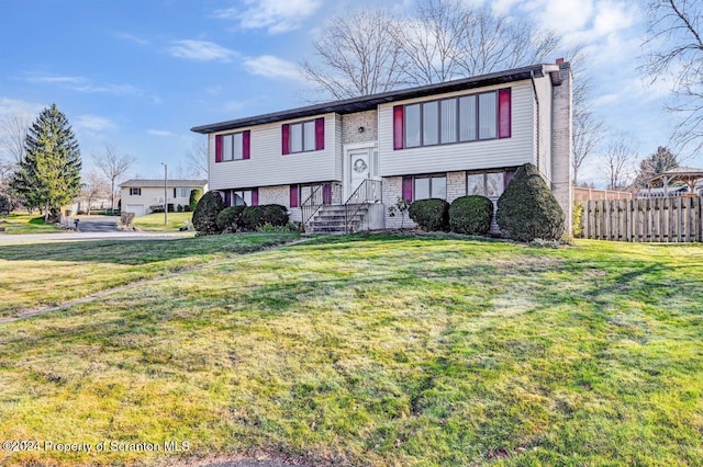 raised ranch featuring a front yard