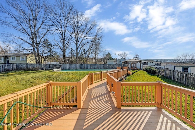 wooden terrace with a gazebo and a lawn