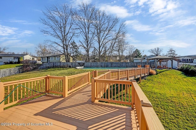 wooden terrace with a gazebo and a yard