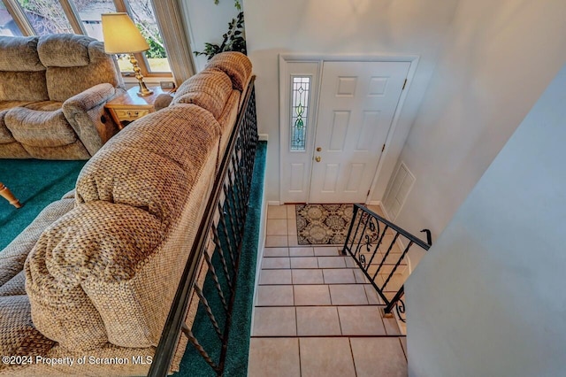 tiled foyer featuring a healthy amount of sunlight