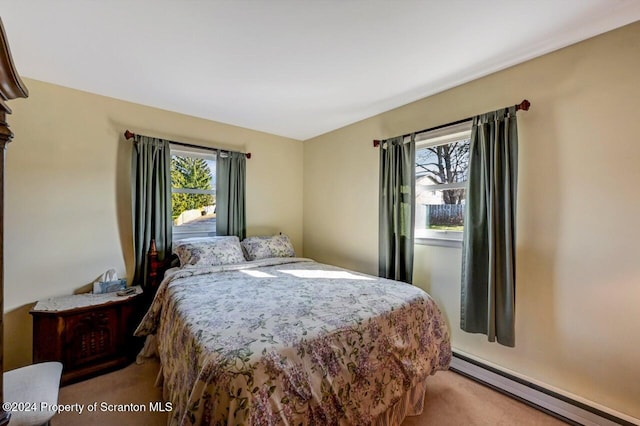 bedroom featuring light carpet and baseboard heating