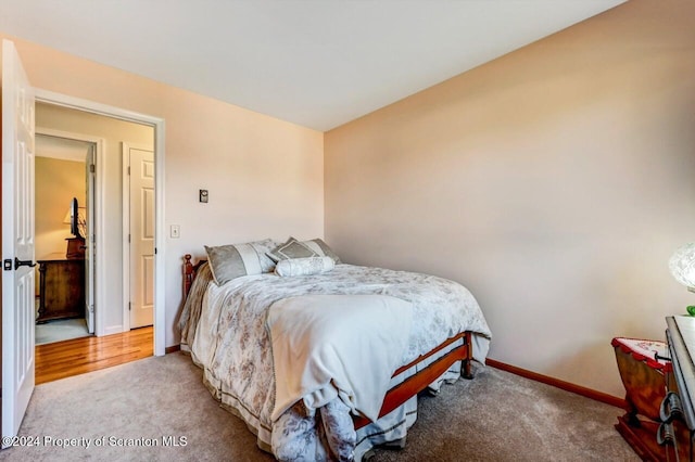 bedroom featuring light carpet