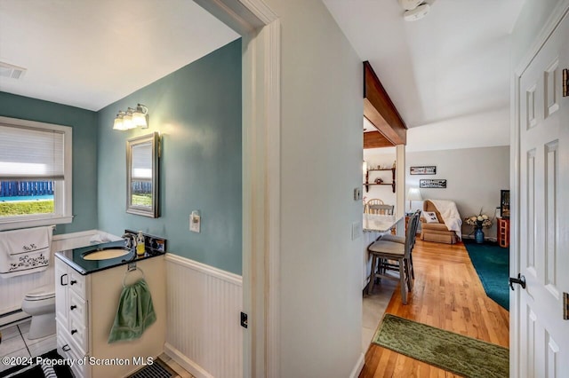 bathroom featuring hardwood / wood-style floors, vanity, and toilet