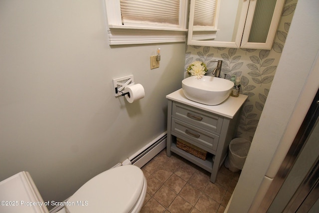 525 N Abington Rd, Waverly Twp, PA 18411 - half bath with a baseboard radiator, vanity, toilet, and tile patterned flooring