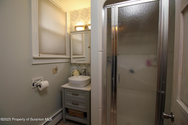 525 N Abington Rd, Waverly Twp, PA 18411 - bathroom featuring a shower stall, vanity, a baseboard radiator, and decorative backsplash