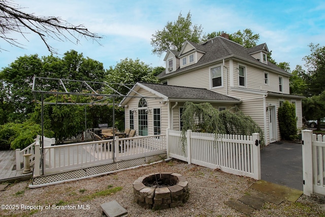 525 N Abington Rd, Waverly Twp, PA 18411 - back of property featuring an outdoor fire pit, a deck, and a shingled roof