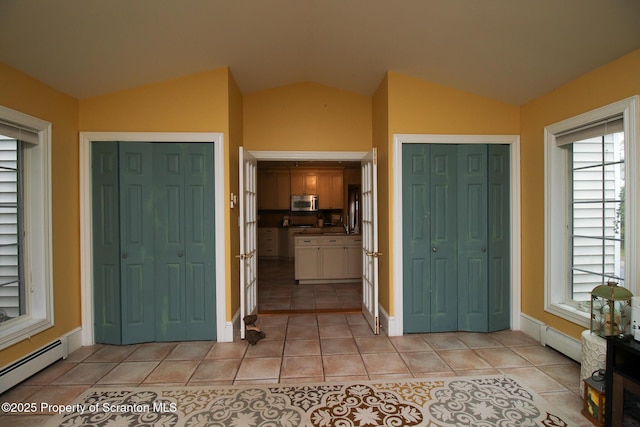 525 N Abington Rd, Waverly Twp, PA 18411 - foyer entrance featuring baseboard heating, lofted ceiling, light tile patterned flooring, and baseboards