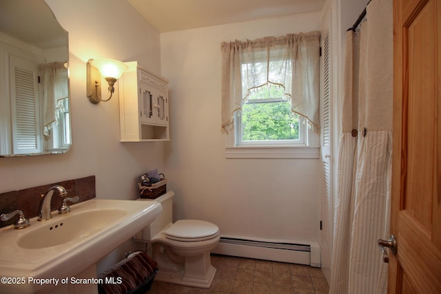 525 N Abington Rd, Waverly Twp, PA 18411 - bathroom featuring a baseboard heating unit, toilet, tile patterned flooring, and a sink