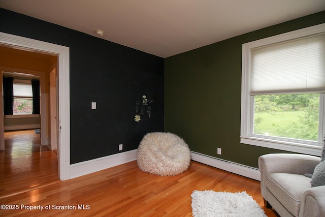 525 N Abington Rd, Waverly Twp, PA 18411 - living area with a baseboard heating unit, light wood-style floors, plenty of natural light, and baseboards