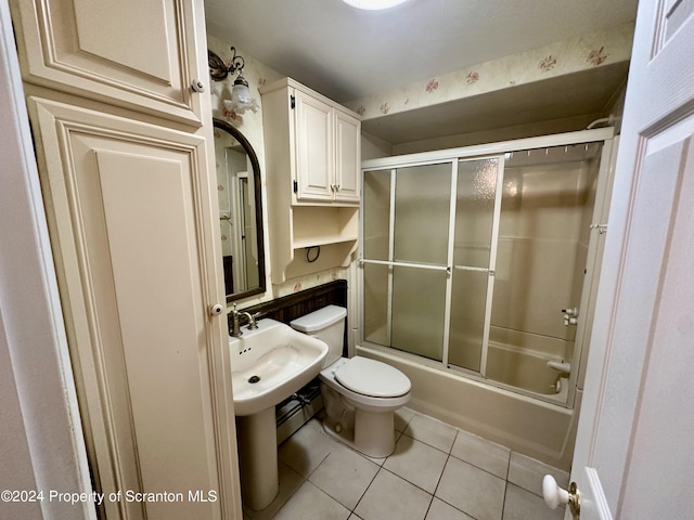 bathroom featuring tile patterned floors, toilet, and enclosed tub / shower combo