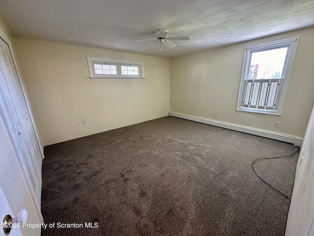 spare room with ceiling fan, a baseboard radiator, and dark carpet