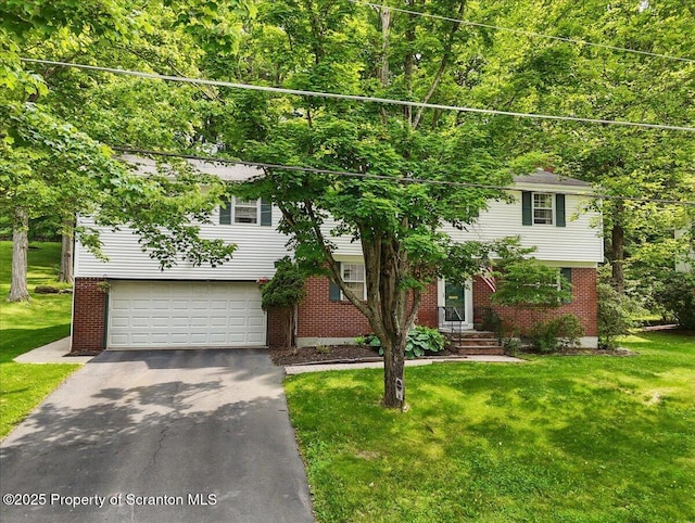 104 Sturbridge Rd, Clarks Summit, PA 18411 - view of front of home with driveway, brick siding, a garage, and a front lawn